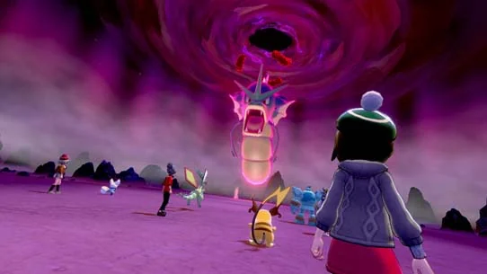 Trainers and their Pokémon face a Dynamax Gyarados in Pokémon Sword and Shield.